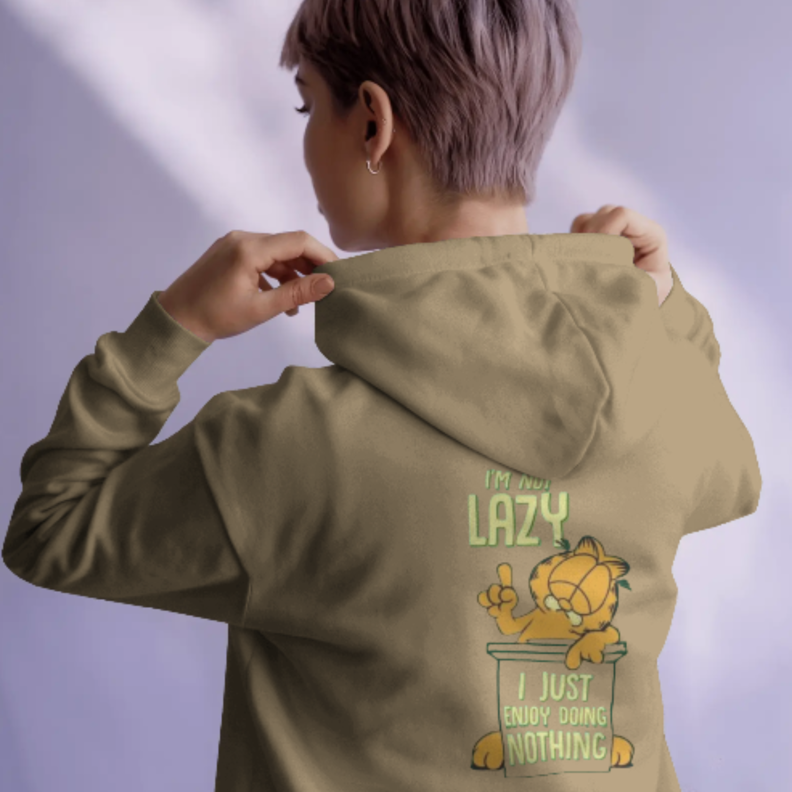 A person wearing a white hoodie with a "I'm not lazy, I just don't care" graphic featuring Garfield on the back.